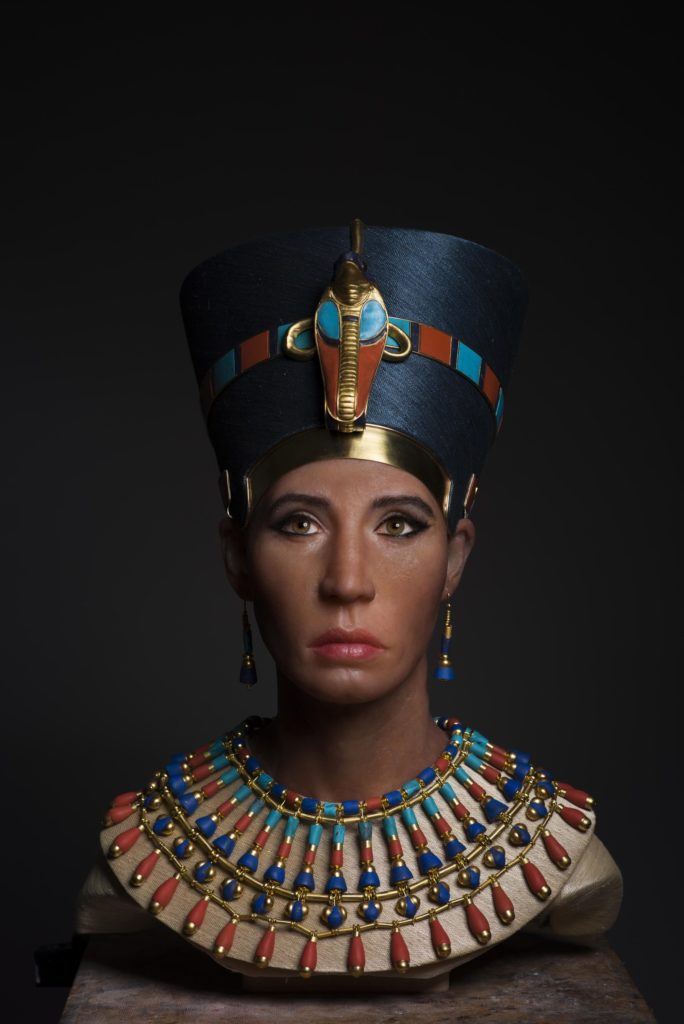 Facial reconstruction bust wearing a blue headdress and a broad, colourful collar.
