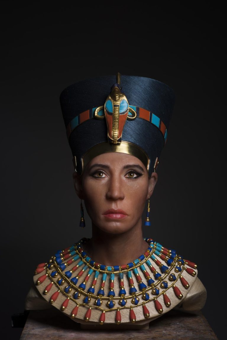 Facial reconstruction bust wearing a blue headdress and a broad, colourful collar.