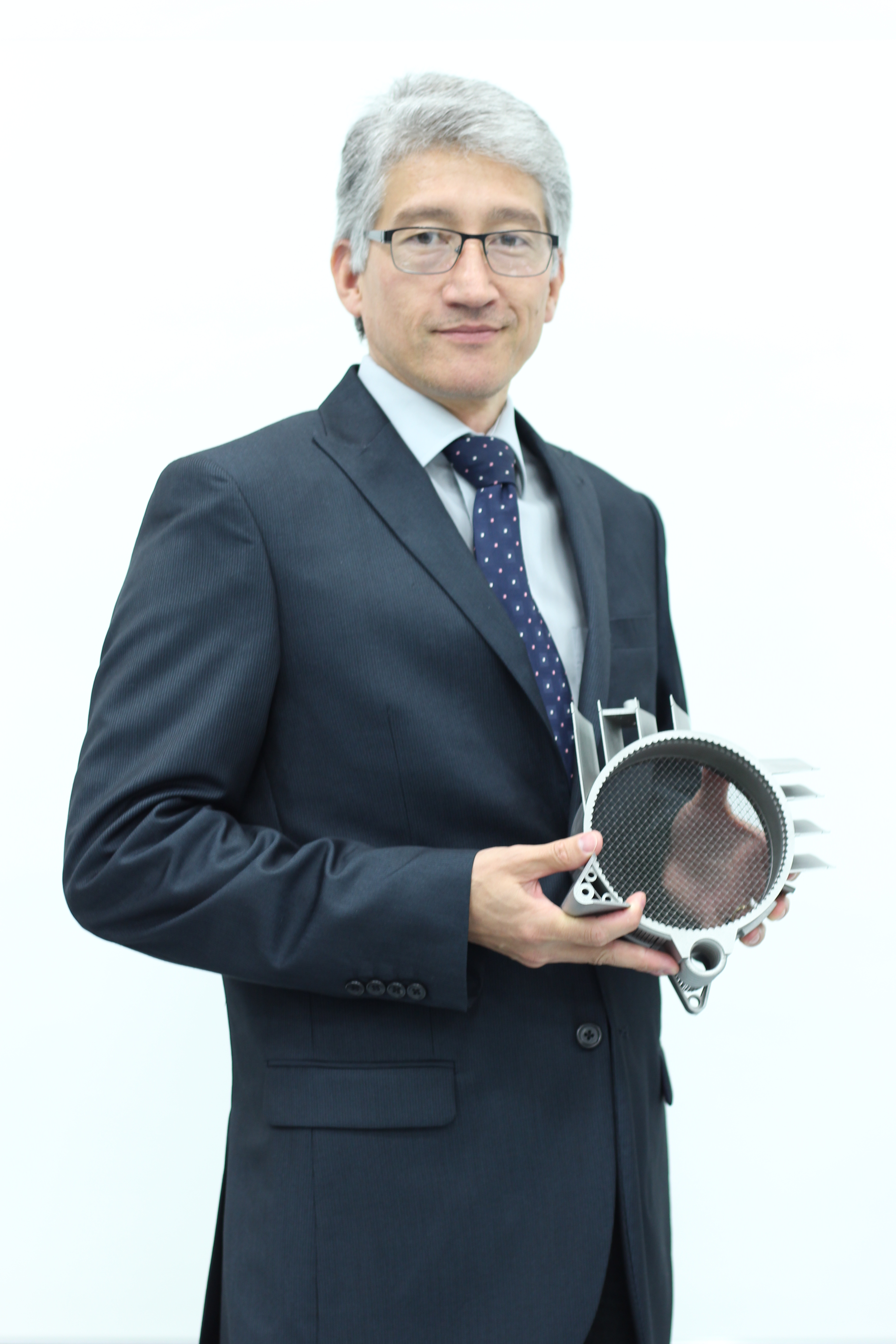 Martin McMahon holding a metal component