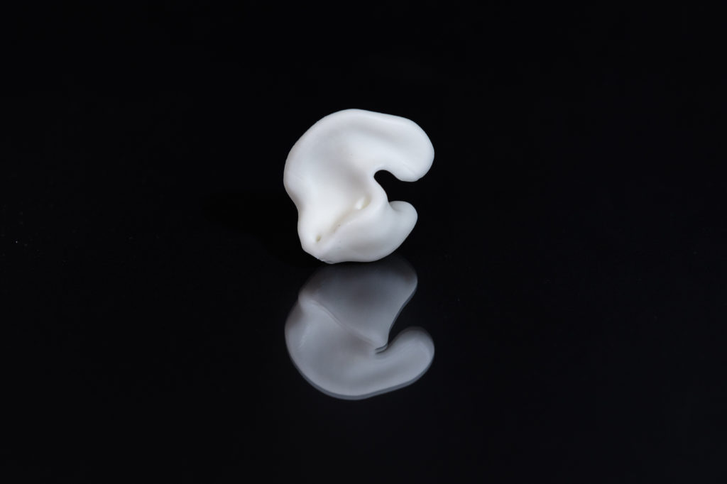 White silicone earpiece illustrating silicone additive manufacturing