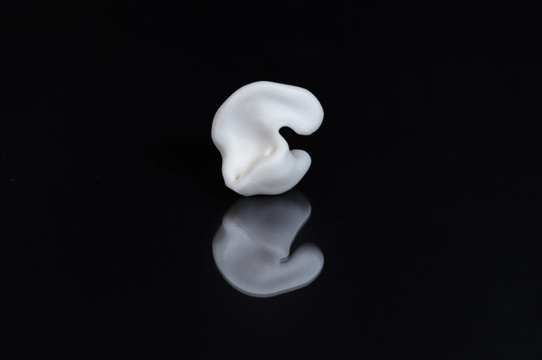 White silicone earpiece illustrating silicone additive manufacturing