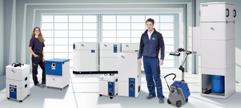 ULT employees beside a range of extraction and filtration equipment.