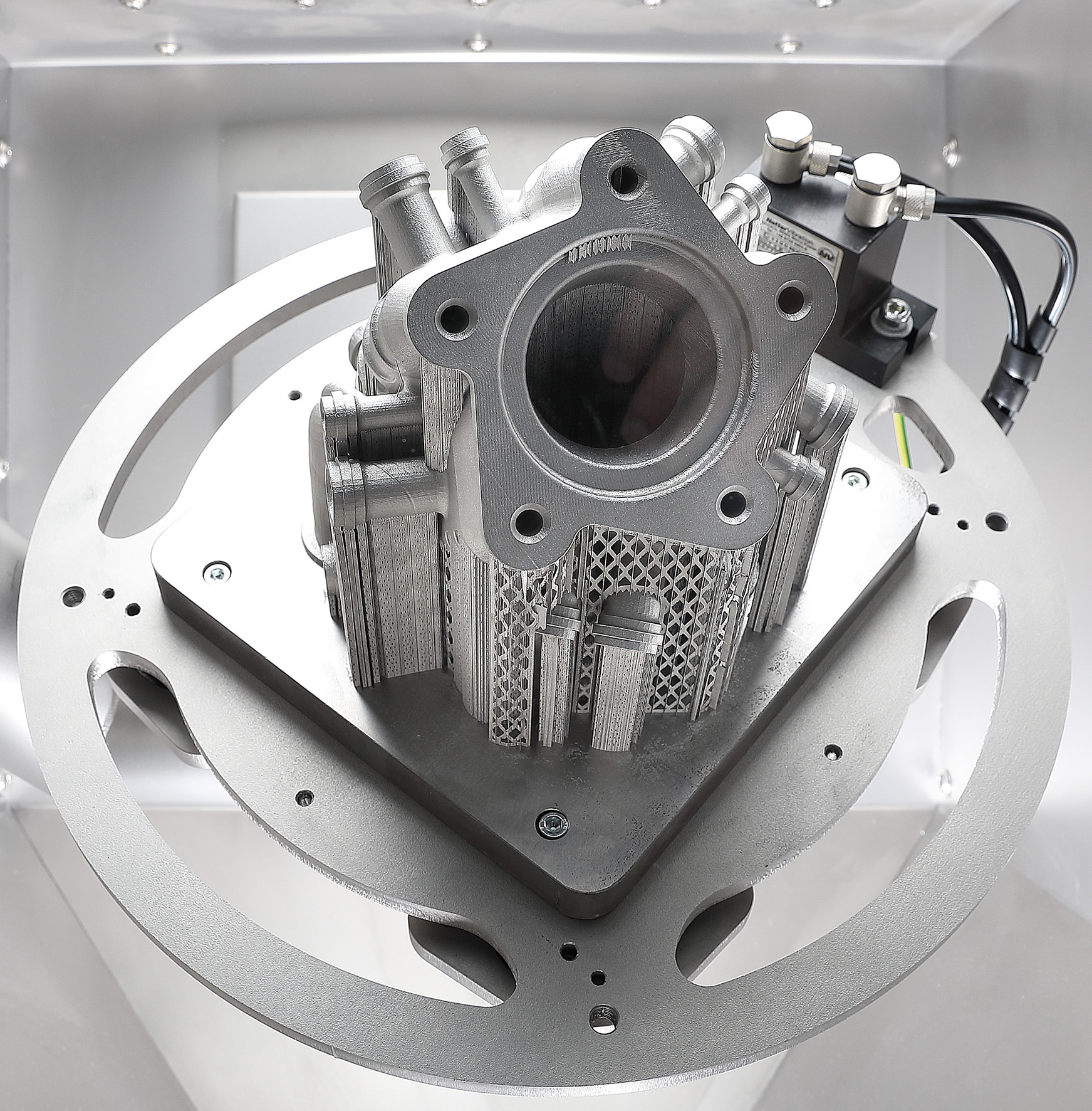 Metal part held inside a Solukon depowdering machine