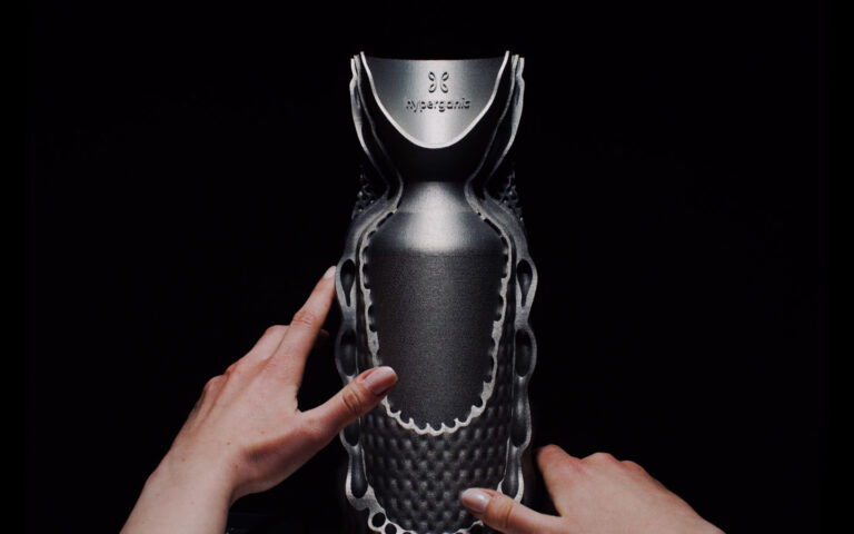Cutaway metal demonstrator with internal passages bearing the Hyperganic name