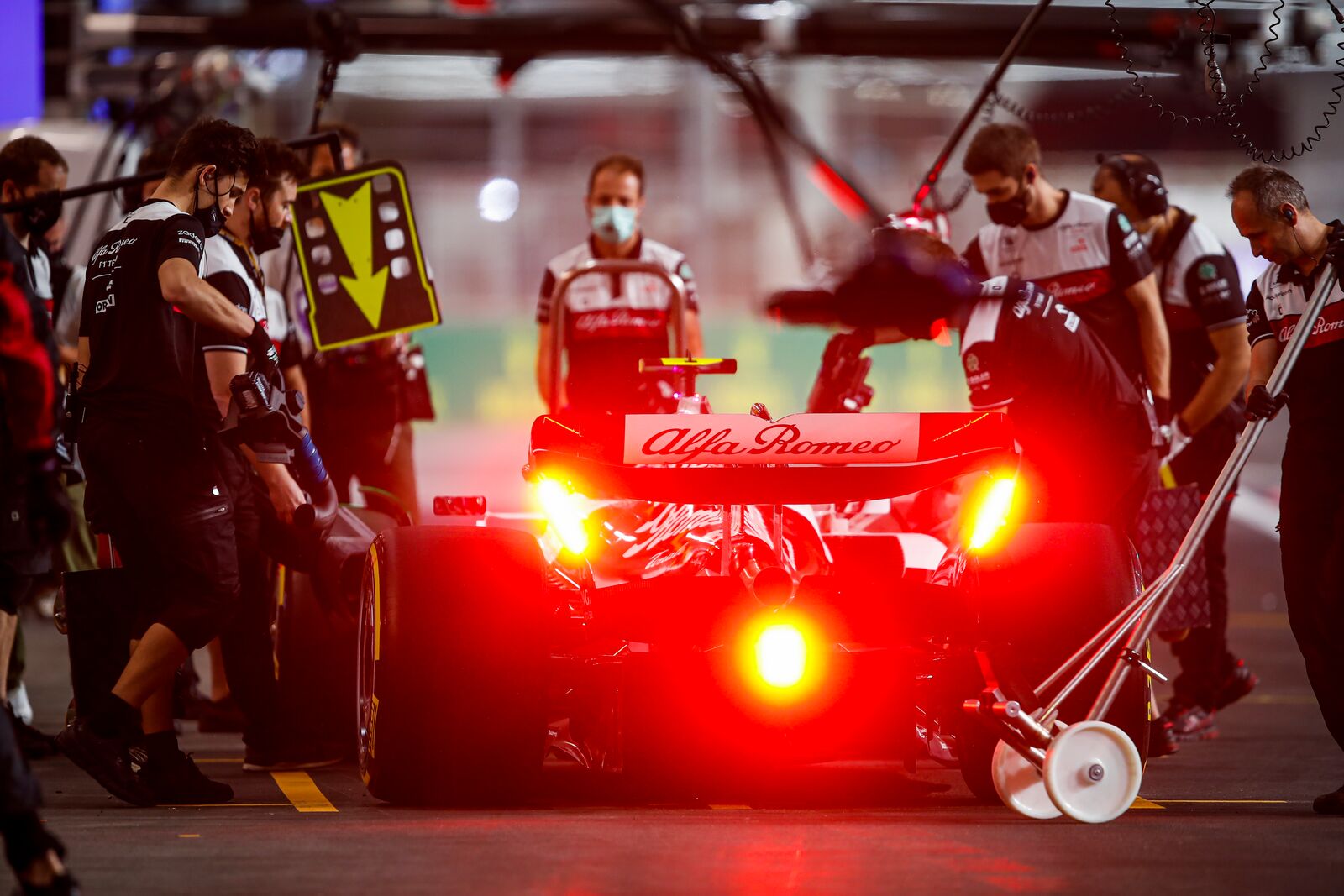 The Alfa Romeo team working in the garage