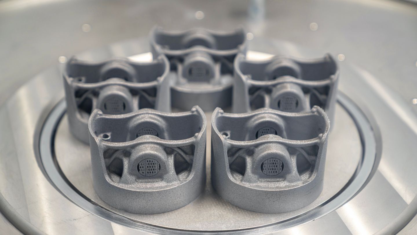Pistons on their build plate before finishing