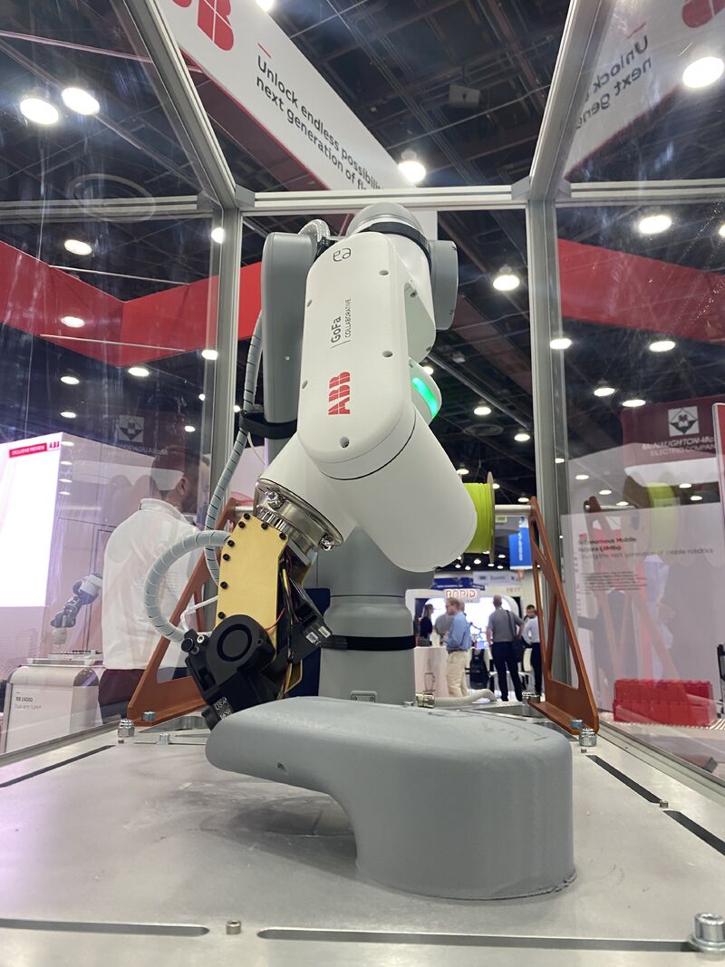 Deposition head mounted on a robotic arm during a demonstration
