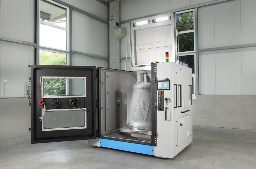 Open Solukon SFM-AT1500-S depowdering system with a large part inside its chamber