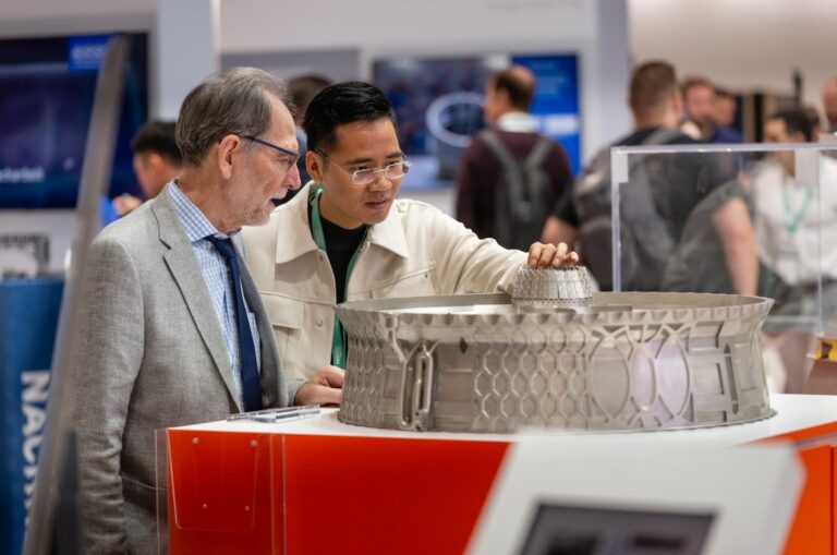 Visitors examining metal parts at Formnext