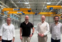 Caracol acquires Weber Additive Image of 4 men in front a manufacturing machine