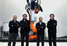 A group of 4 men in front of a machine