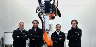 A group of 4 men in front of a machine