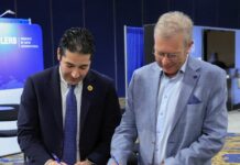 Two men signing a MoU