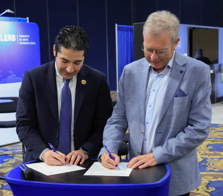 Two men signing a MoU