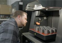 ALOFT AeroArchitects & Spectrum Network produce flight-ready parts with composite 3D printing Man looking at parts in a 3D printer