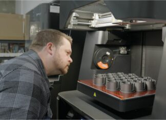 ALOFT AeroArchitects & Spectrum Network produce flight-ready parts with composite 3D printing Man looking at parts in a 3D printer
