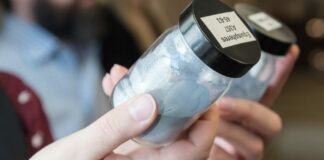 Woman looking at powder in a small container