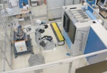 Robot connected to a depowdering system