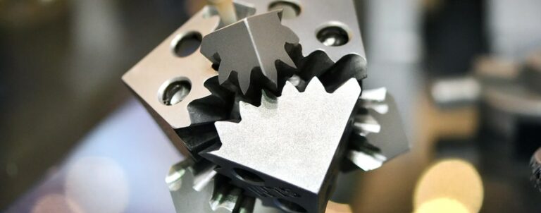 Interlocking metal components with toothed profiles.