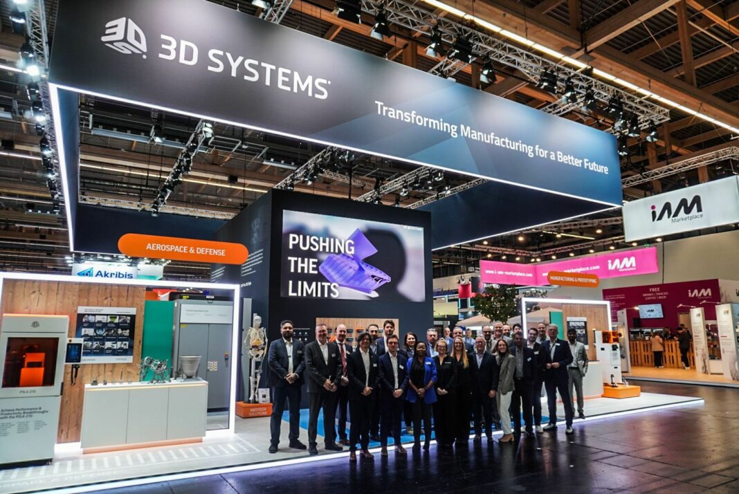 A group of people gathered for a picture in front of a booth