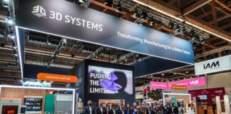 A group of people gathered for a picture in front of a booth