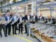 A group of Airbus employees holding a Titanium 3D printed part for the Airbus A350
