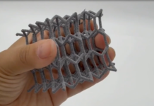 ADDMAN expands its polymer 3D printing production capabilities through acquisition of Forecast 3D A hand holdin a polymer 3D printed part