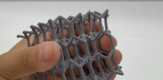A hand holdin a polymer 3D printed part