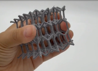 A hand holdin a polymer 3D printed part