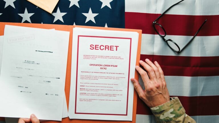 Illustrative image of a document marked secret in front of a U.S. flag