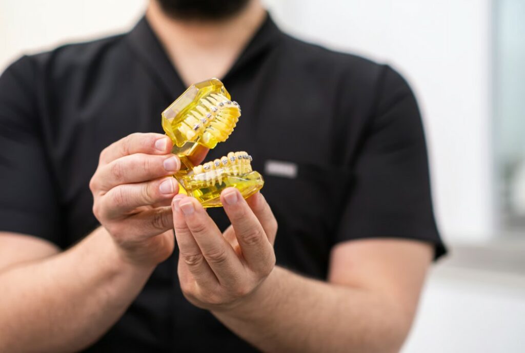Man holding a dental implant