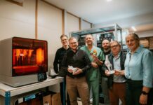 A group of people gathered in a 3D printing lab