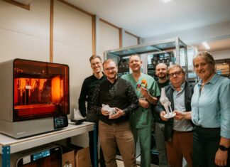 A group of people gathered in a 3D printing lab