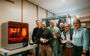 A group of people gathered in a 3D printing lab