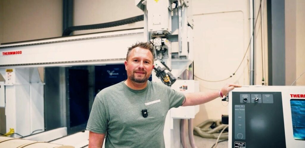 Man standing in front of a CNC machine