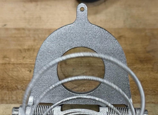 Close-up of the additively manufactured titanium deployment spring inside the JPL Additive Compliant Canister (JACC), highlighting the integrated mechanism design made possible by additive manufacturing.