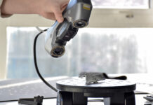 Hand 3D scanning an object