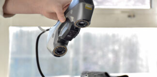 Hand 3D scanning an object