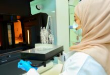 Woman removing a 3D printed part from the 3D printer