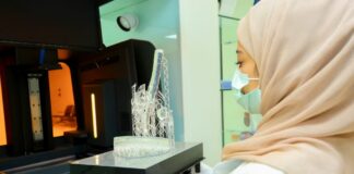 Woman removing a 3D printed part from the 3D printer