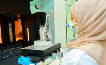Woman removing a 3D printed part from the 3D printer