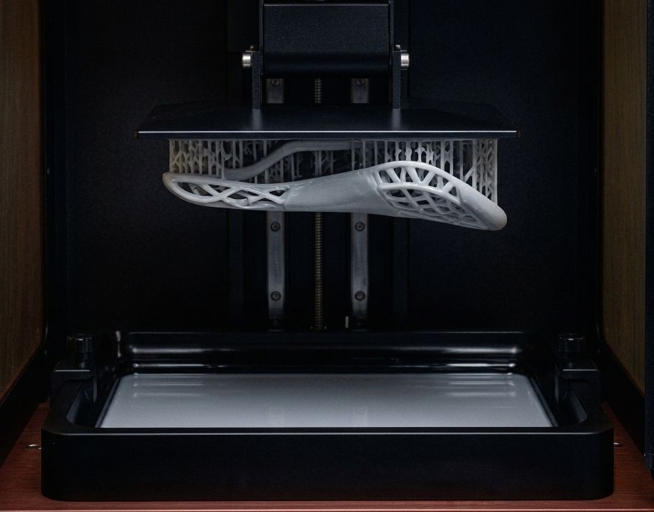 Saddle coming out of a 3D printer, on a build plate