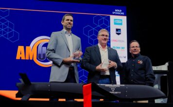 2 keynote speakers receiving their award at AMUG 2026, award given by the MC, Todd Grimm on the picture as well