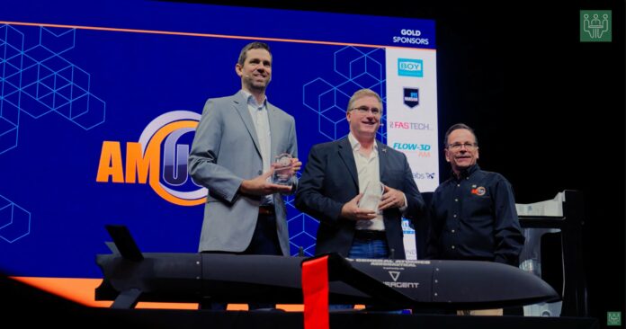 2 keynote speakers receiving their award at AMUG 2026, award given by the MC, Todd Grimm on the picture as well