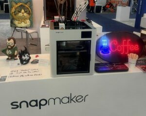 U1 x Cocoapress Edition 3D printer on a booth at RAPID+TCT 2026 in Boston