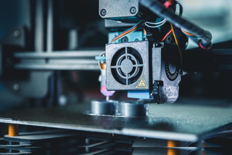 Extrusion print head depositing material on a 3D printer build plate.