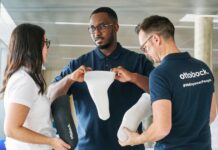 3 people looking at iconiq: Ottobock's 3D printed liner that makes personalized prosthetic care the norm