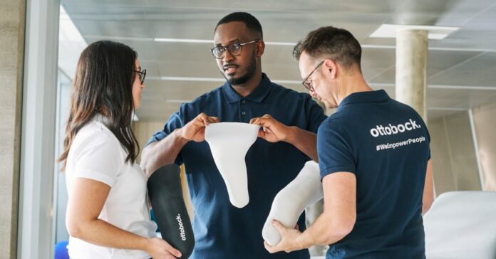 3 people looking at iconiq: Ottobock's 3D printed liner that makes personalized prosthetic care the norm