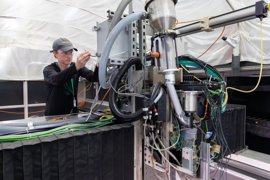 Chris O’Brien sets up the sensor-equipped large-scale 3D printer at ORNL.