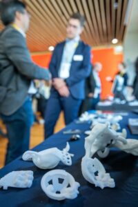 3D printed medical parts displayed on a table at a conference